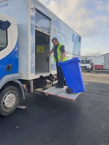 Lifting a shredding bin on to the truck